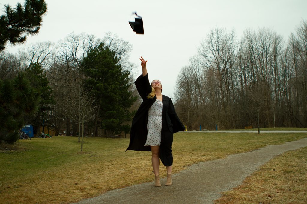 Graduate throwing cap in air