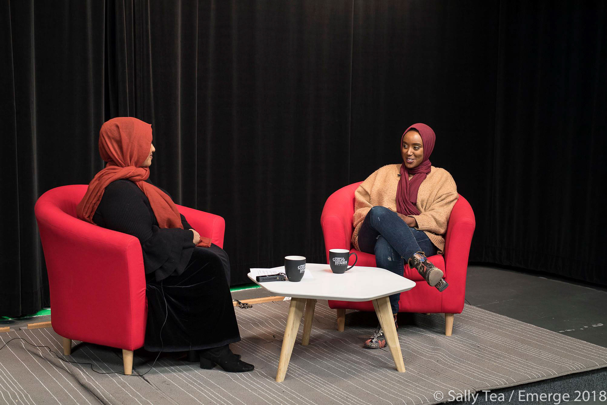 Eman bare being interviewed by writer; Haazifah