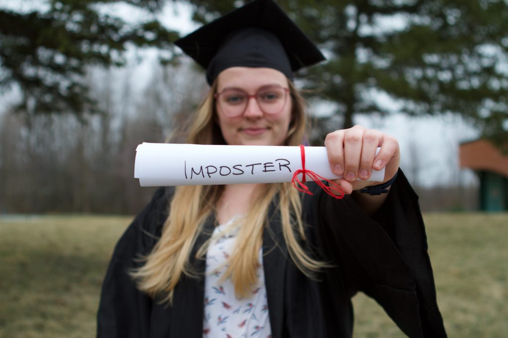Graduate showing off "Imposter Degree"