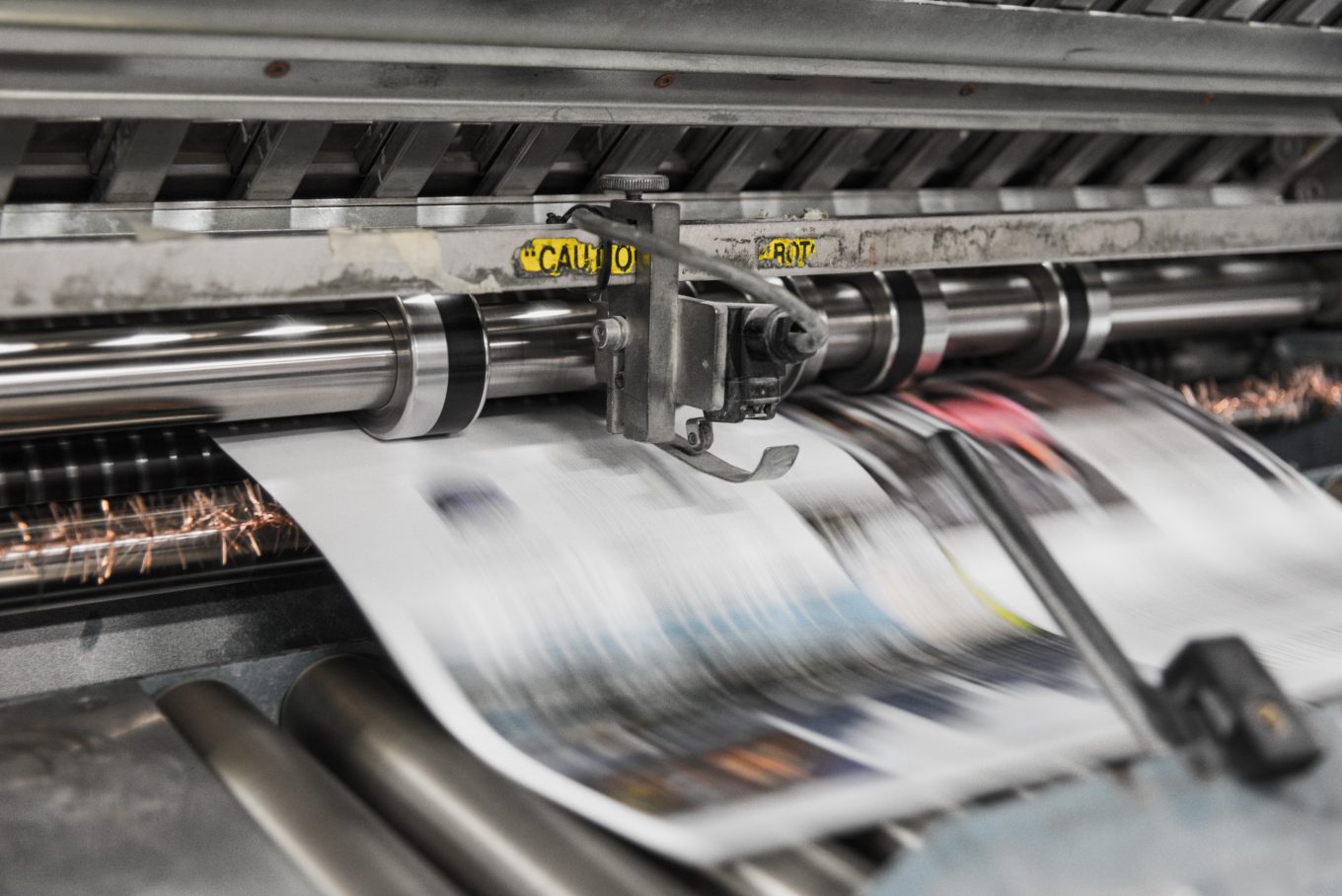 Photograph of an industrial printer printing magazine